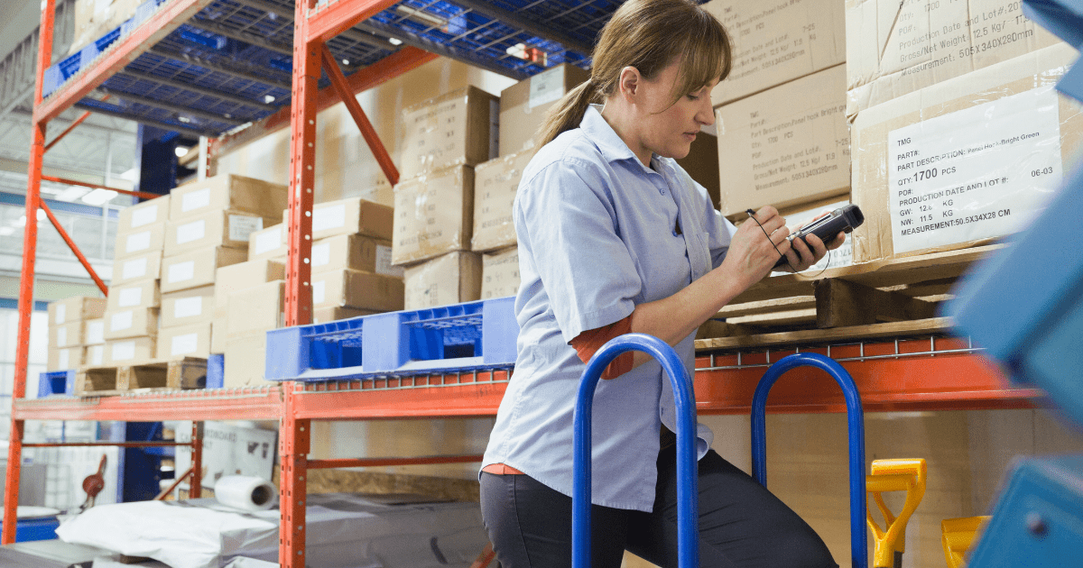 Warehouse female employee checking inventory
